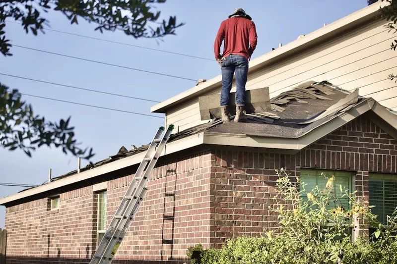 Professional roofer working on a residential roof in Friendly Hills